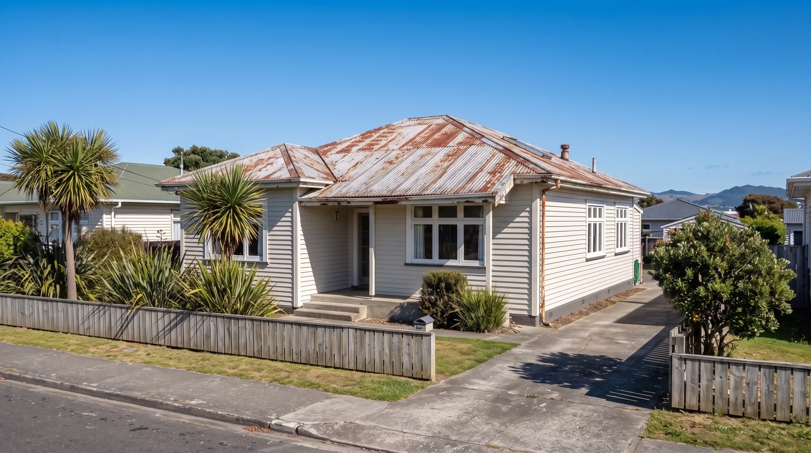 Before: weatherboard bungalow with a rusted corrugated iron roof